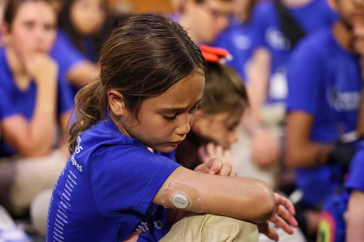 A child with type 1 diabetes wears her Continuous Glucose Monitor.