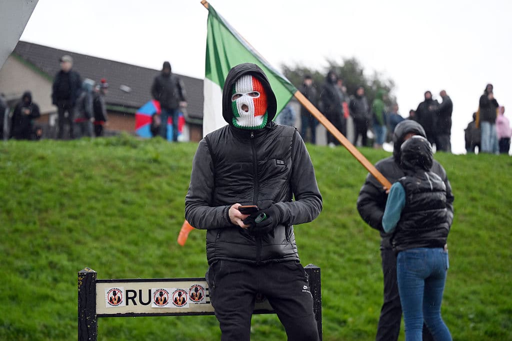 A protestor in an Irish flag balaclava at Portadown, Northern Ireland, September 29, 2026. .