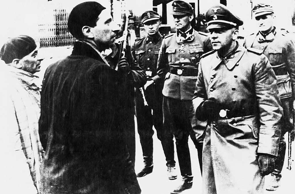 SS General Jürgen Stroop interrogates Jews during the destruction of the Warsaw Ghetto, 1943.