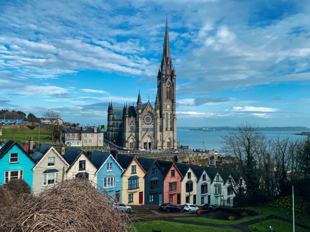 St. Colman's Cathedral in Cobh, Ireland, rises above the colorful "Deck of Cards" houses along the Cork coastline.