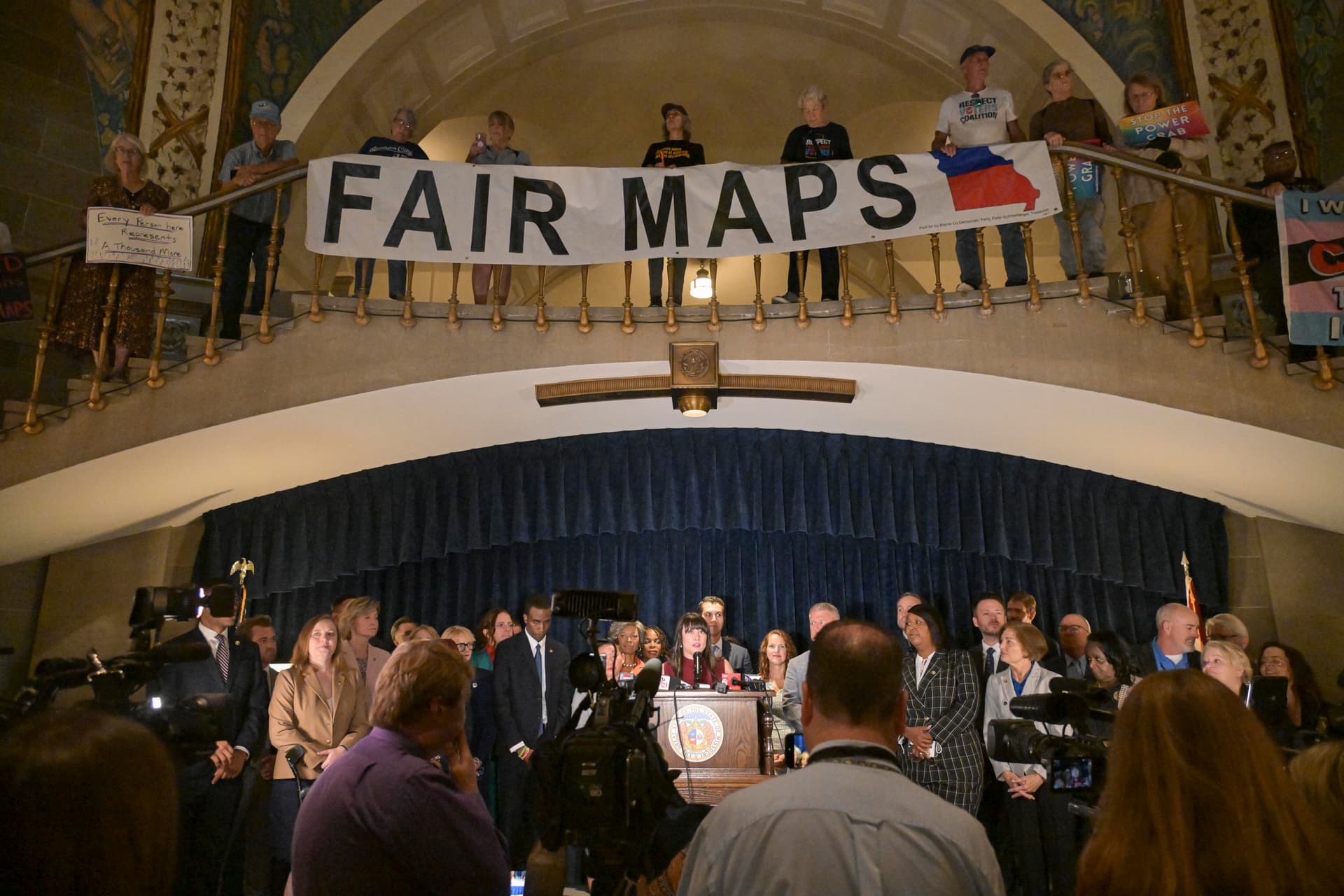 Activists display signs inside the rotunda of the State Capitol Building at Jefferson City, Missouri, on September 10, 2025.