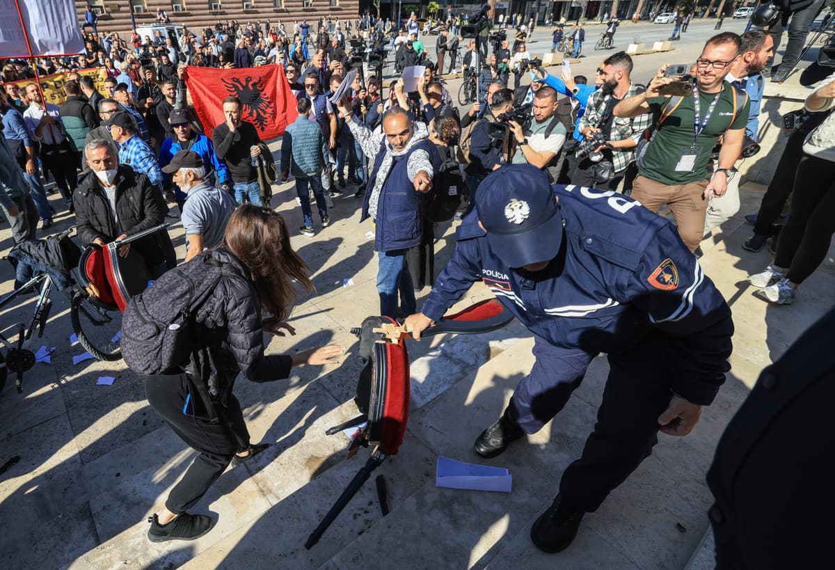 Protesters overturn chairs set up by the prime minister's office for a ‘dialogue’ outside a government building at Tirana, Albania, on October 20, 2026.