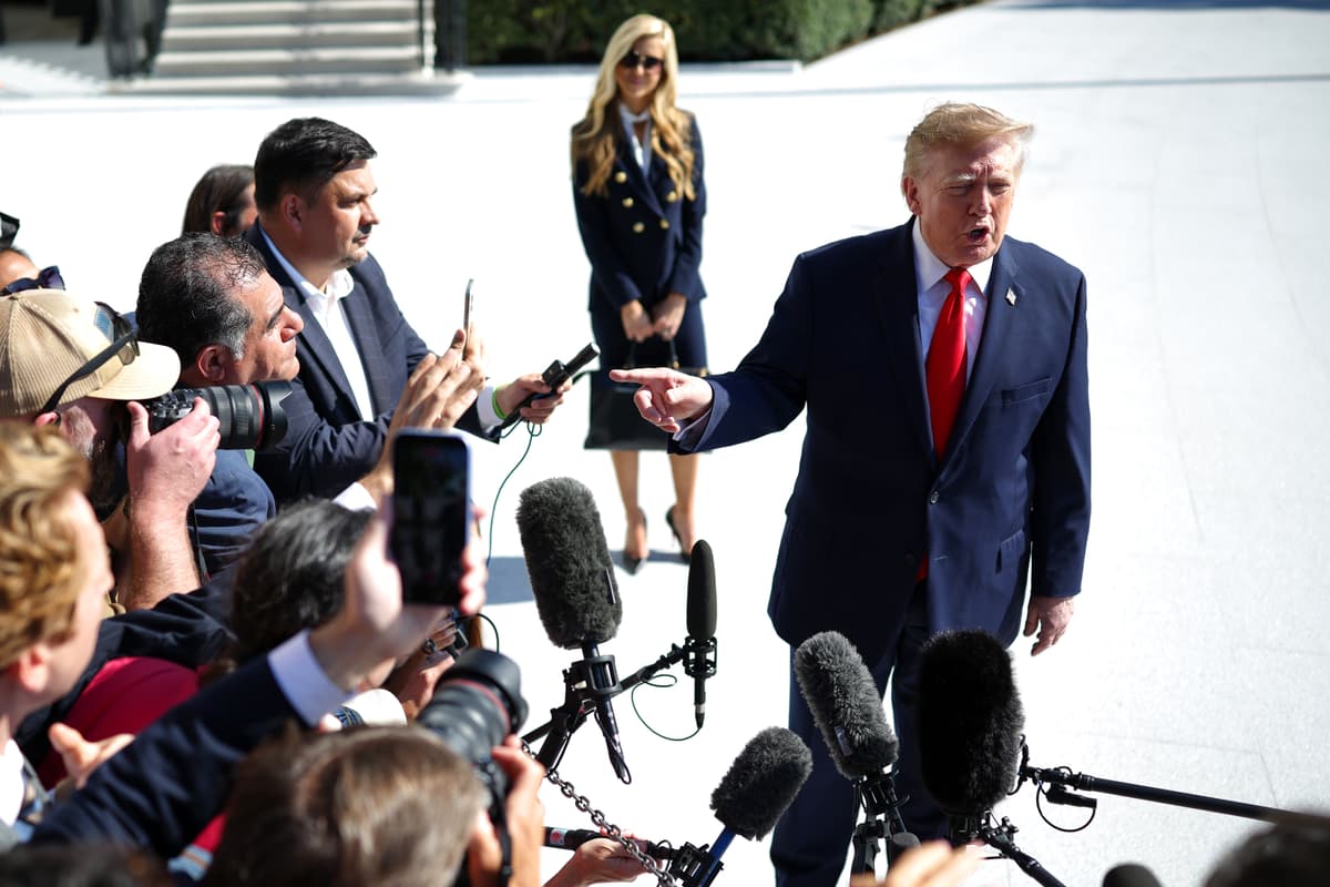 The White House press secretary, Katie Zacharia, looks on as President Trump speaks to reporters on the South Lawn of the White House before traveling to Alaska on October 13, 2026.