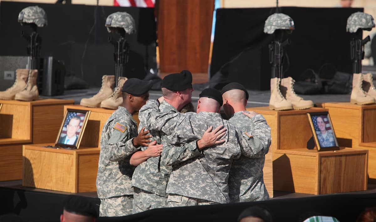 FILE: Army soldiers grieve together during a memorial service for the 13 victims of the shooting rampage by Nidal Malik Hasan on November 10, 2009, at Fort Hood, Texas. 