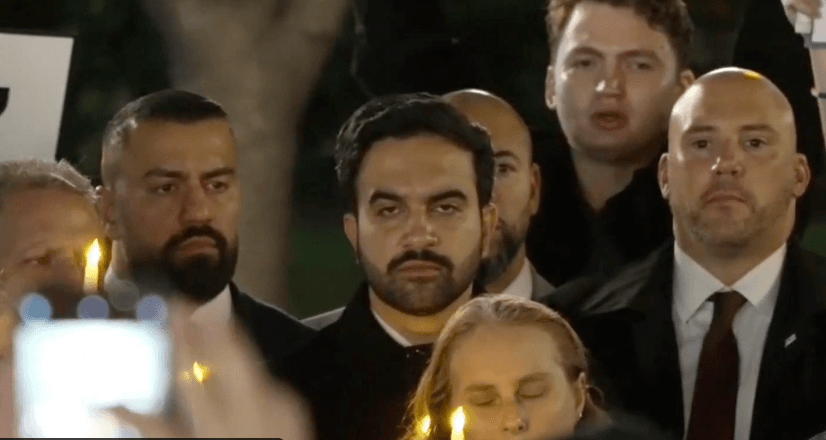 Mayor Zohran Mamdani scowls as he is heckled at an October 7 vigil at New York City.