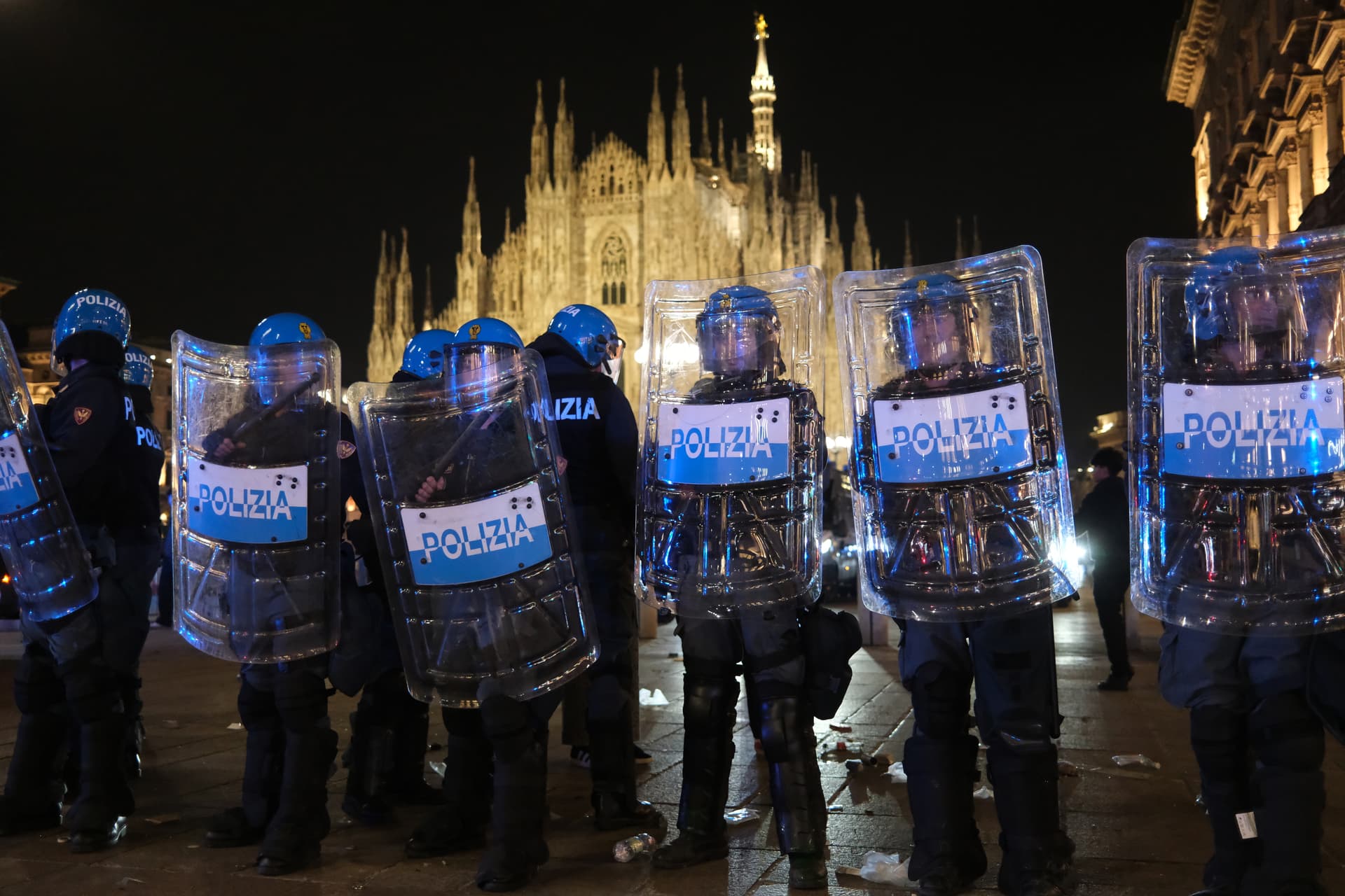 Police stand guard outside the Milan's cathedral after protests turned violent on October 17, 2026. 