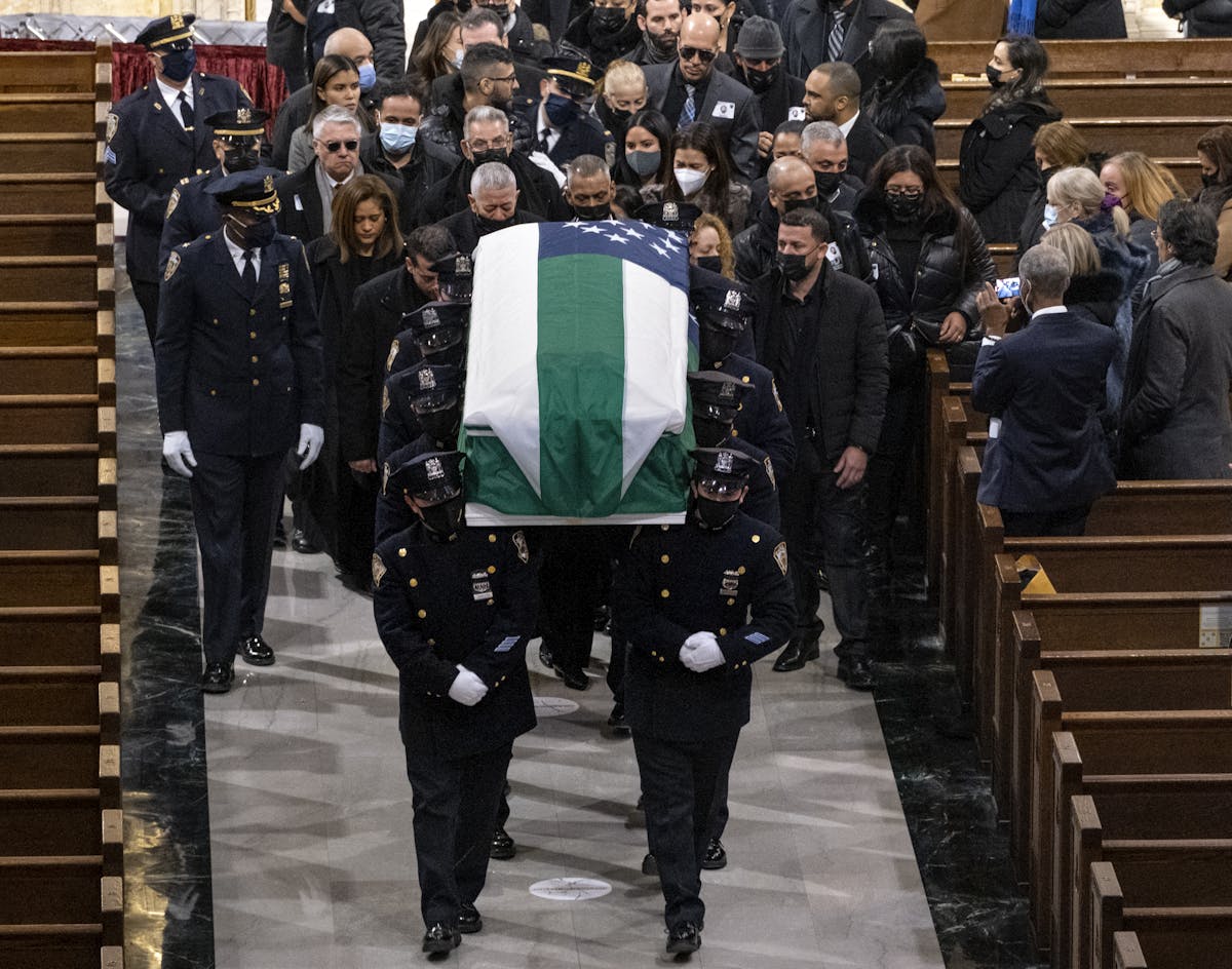 Slain NYPD officer Wilbert Mora's casket is carried at the completion of a funeral service at St. Patrick's Cathedral in New York February 2, 2022. Craig Ruttle/Newsday via AP, pool