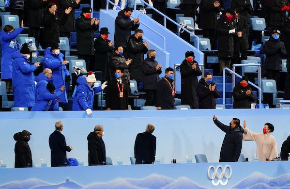 President Xi, bottom, waves as he arrives for the opening ceremony of the 2022 Winter Olympics, February 4, 2022, in Beijing. AP/Matt Slocum