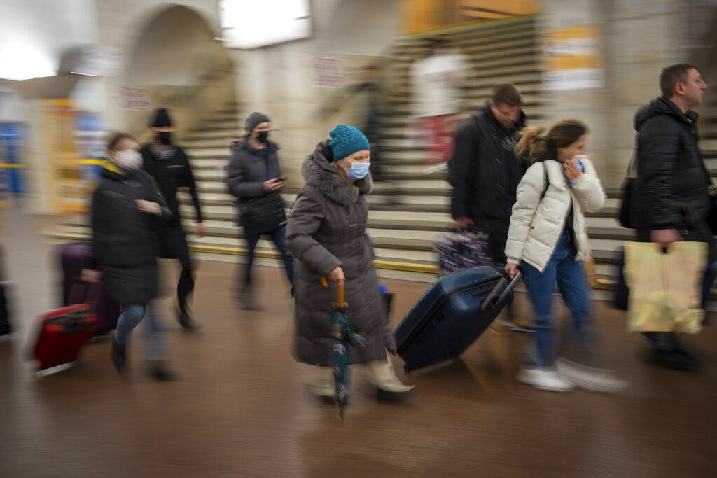 People walk in a subway to get a train as they leave the city of Kyiv, Ukraine, on Thursday. AP Photo/Emilio Morenatti