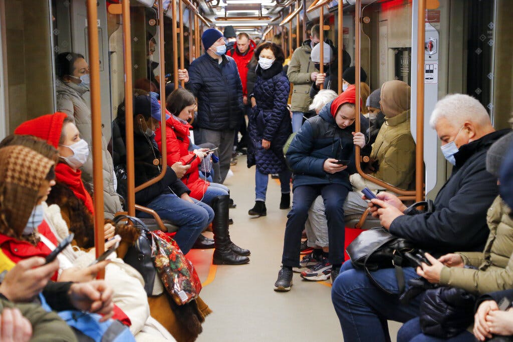 People check their phones while on a Moscow subway. AP/Alexander Zemlianichenko Jr.