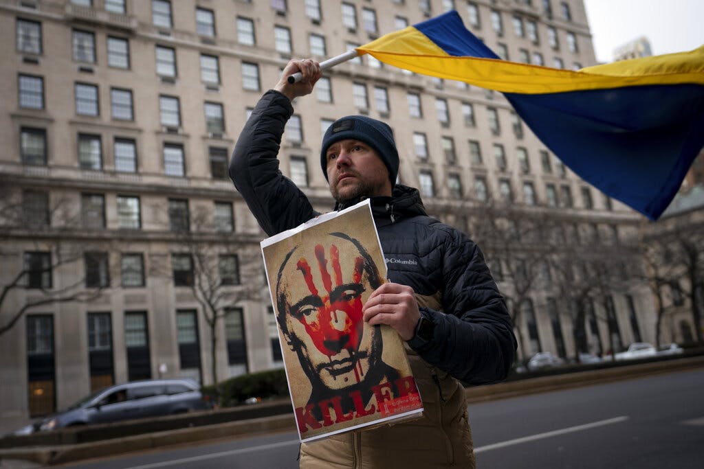 A supporter of Ukrainian sovereignty protests the Russian invasion of Ukraine, February 24, 2022, at New York. AP/John Minchillo