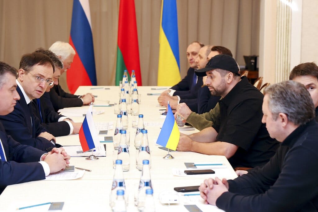 The head of the Russian delegation, Vladimir Medinsky, second left, and faction leader of the Servant of the People party in the Ukrainian Parliament, Davyd Arakhamia, third right, attend the peace talks at Belarus February 28, 2022. Sergei Kholodilin/BelTA pool photo via AP