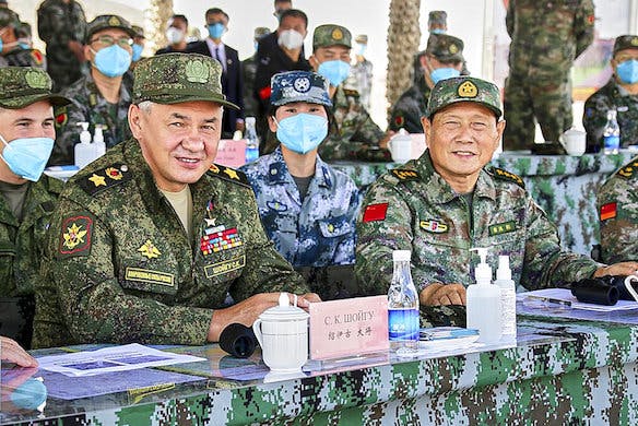 The Russian defense minister, Sergei Shoigu, and the Chinese defense minister, Wei Fenghe, watch a joint military exercise August 13, 2021. Vadim Savitskiy/Russian Defense Ministry Press Service via AP, file