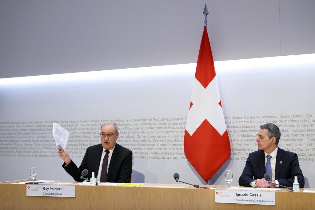 Federal Councillor Guy Parmelin, left, speaks alongside Federal President Ignazio Cassis during a conference at Bern in February. AP/Anthony Anex/Keystone