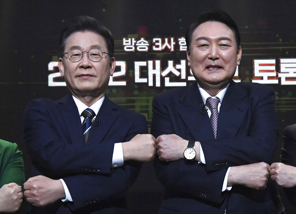 Lee Jae-myung, left, and Yoon Suk-yeol pose before a televised debate February 3, 2022. Yonhap via AP, File