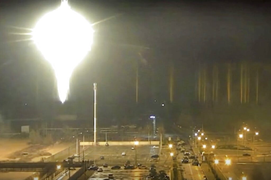 An image made from a video released by Zaporizhzhia nuclear power plant shows a bright, flaring object landing at grounds of the nuclear plant in Enerhodar, Ukraine, March 4, 2022. Zaporizhzhia nuclear power plant via AP