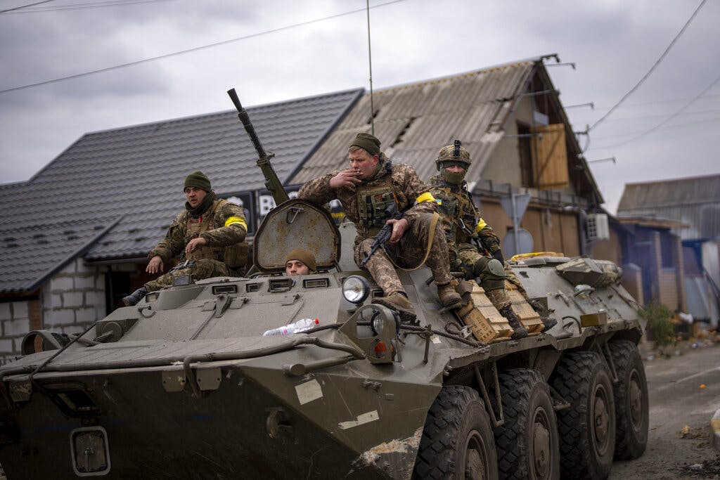 Ukrainian soldiers drive on an armored military vehicle at the outskirts of Kyiv March 5, 2022. AP/Emilio Morenatti