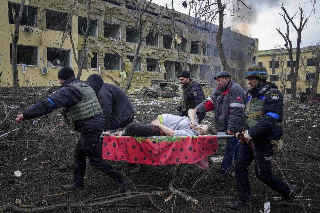 A pregnant woman is carried from the maternity hospital at Mariupol, Ukraine, March 9, 2022. AP/Evgeniy Maloletka