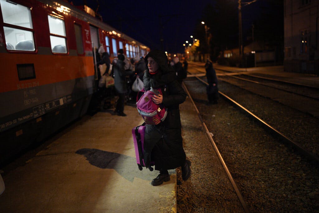 Refugees board a train at the Medyka border crossing, Poland. AP Photo/Daniel Cole