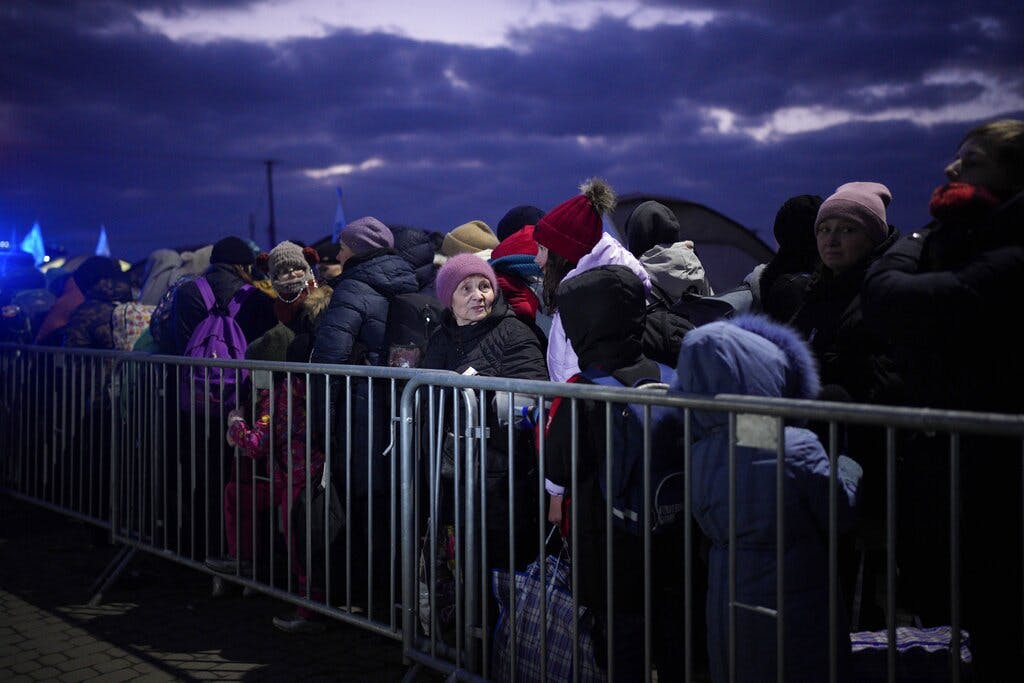 Refugees fleeing the Ukraine war gather at the Medyka border crossing, Poland, March 10, 2022. AP/Daniel Cole