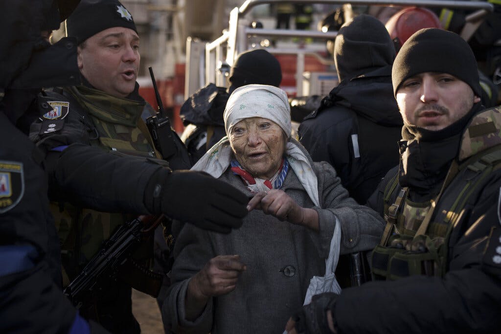 A woman is after she was rescued by firefighters from her apartment after a bombing attack at Kiev March 15, 2022. AP/Felipe Dana