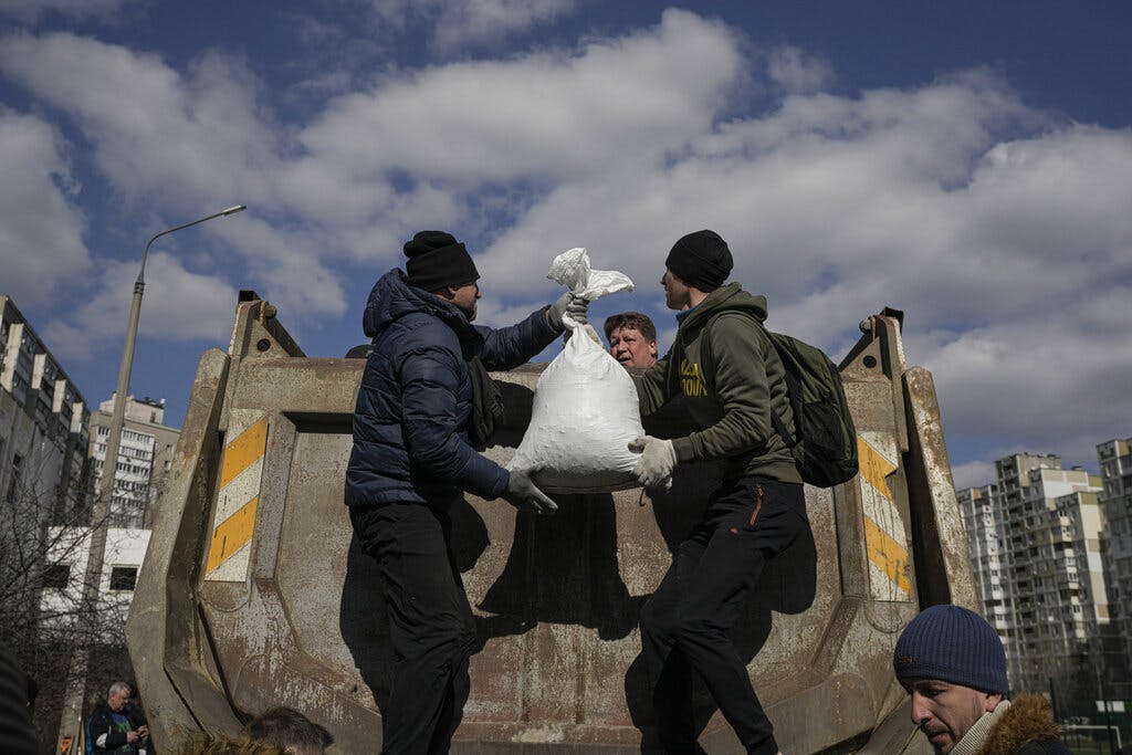 Debris is cleared outside a Kiev medical center damaged after parts of a Russian missile, shot down by Ukrainian air defense, landed on a nearby apartment block March 17, 2022. AP/Vadim Ghirda