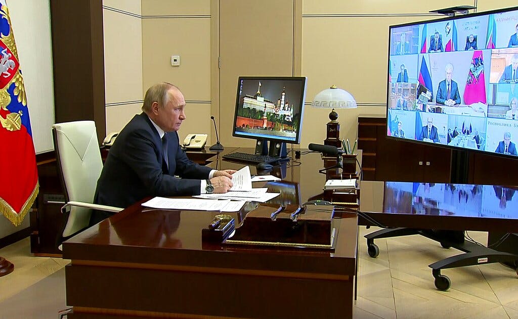 In a photo taken from video, President Putin is seen speaking via videoconference at the Novo-Ogaryovo residence outside Moscow March 16, 2022. Russian Presidential Press Service via AP, file