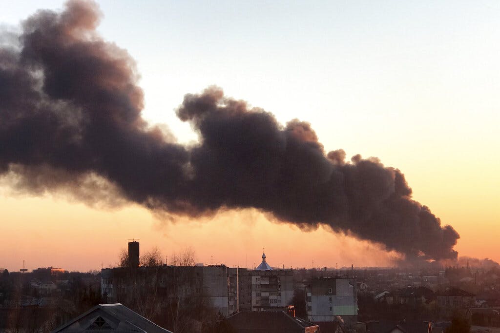 A cloud of smoke raises after an explosion at Lviv, western Ukraine, March 18, 2022. AP
