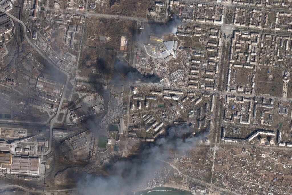 Civilian buildings burning amid Russian strikes at Mariupol, Ukraine. Planet Labs PBC via AP