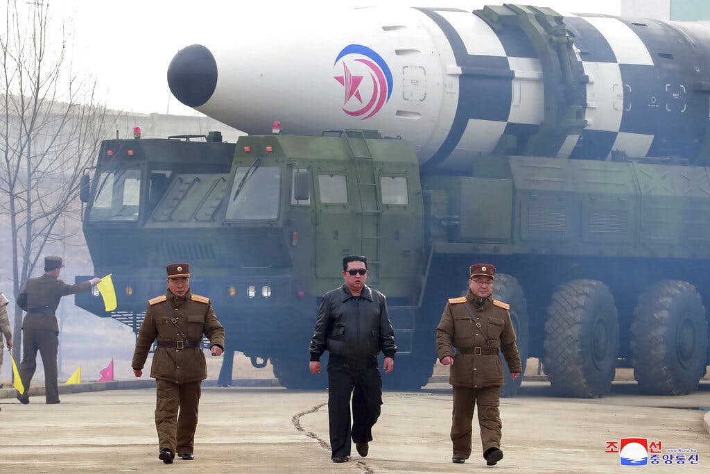 The North Korean leader, Kim Jong Un, center, near what North Korea says is a Hwasong-17 intercontinental ballistic missile March 24, 2022.  Korean Central News Agency/Korea News Service via AP