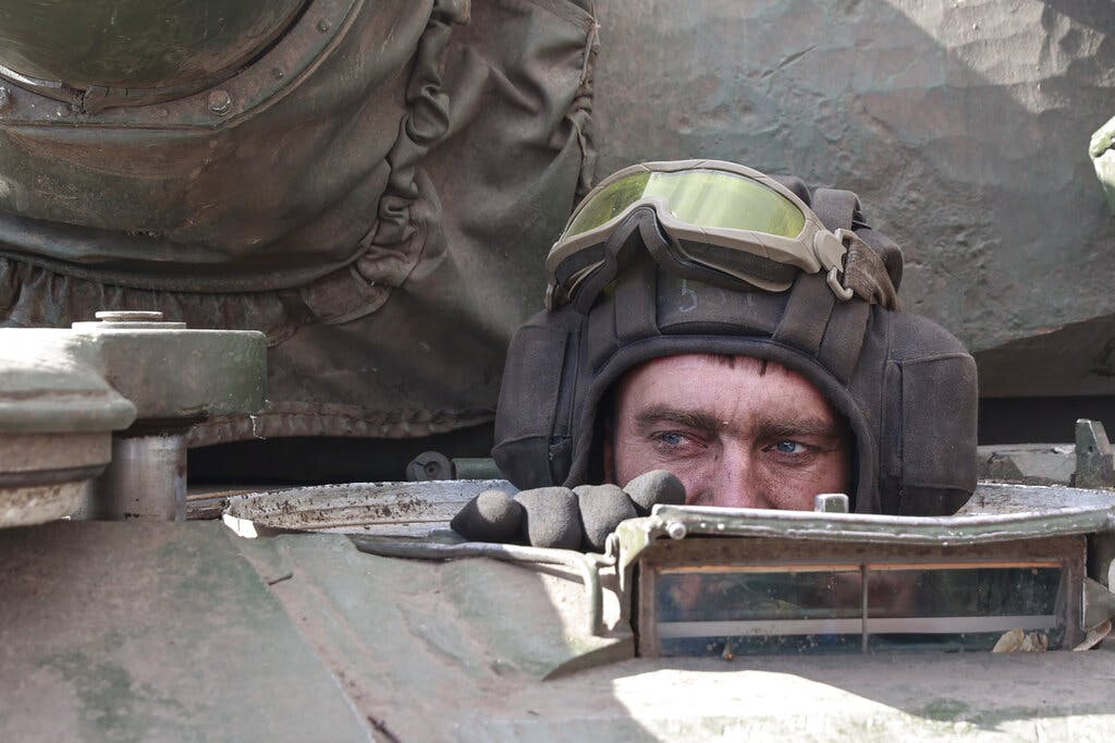 A Ukrainian serviceman looks out from a tank at the village of Lukyanivka, Kiev region, March 27, 2022. AP