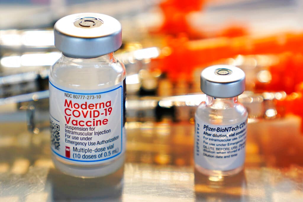 AP/Charles Krupa Vials of the Moderna and Pfizer Covid-19 vaccines.
