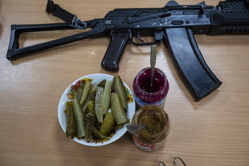 A Ukrainian soldier’s lunch condiments and machine gun March 31, 2022. AP/Rodrigo Abd