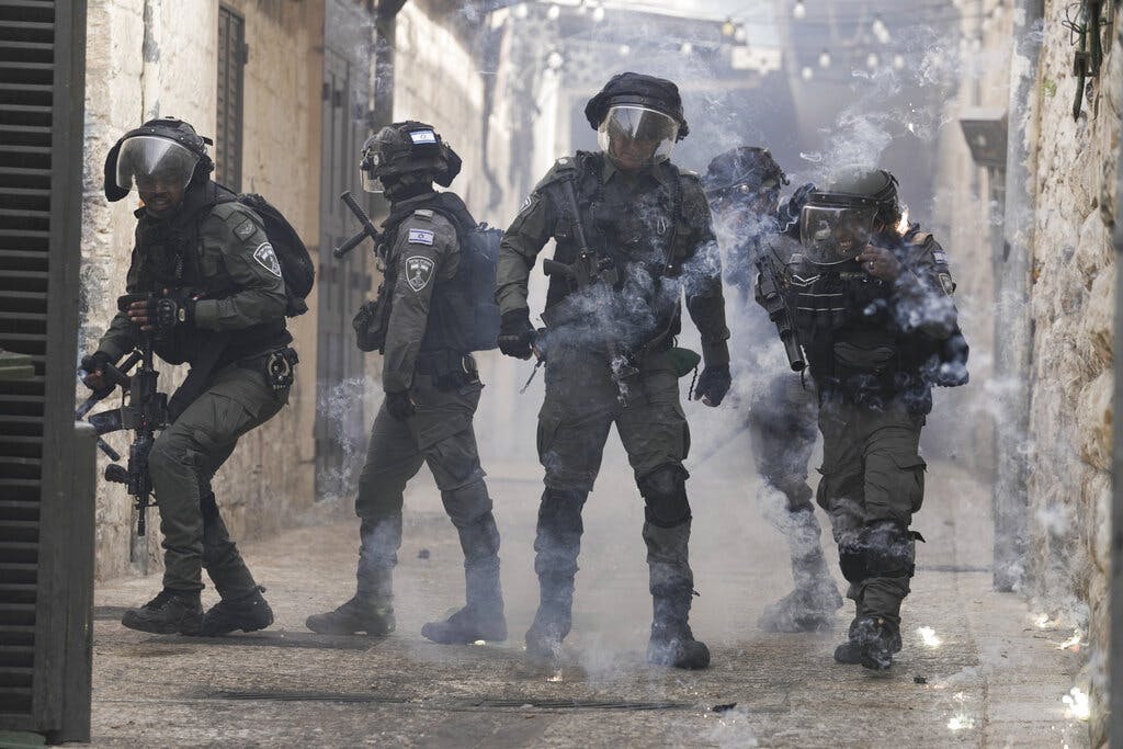 Palestinians shoot fireworks at Israeli police at the Old City of Jerusalem April 17, 2022. AP/Mahmoud Illean