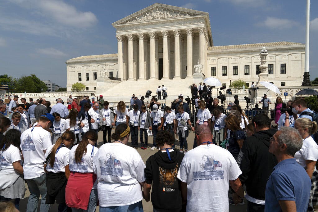 People pray outside of the U.S. Supreme Court May 3, 2022. AP/Jose Luis Magana