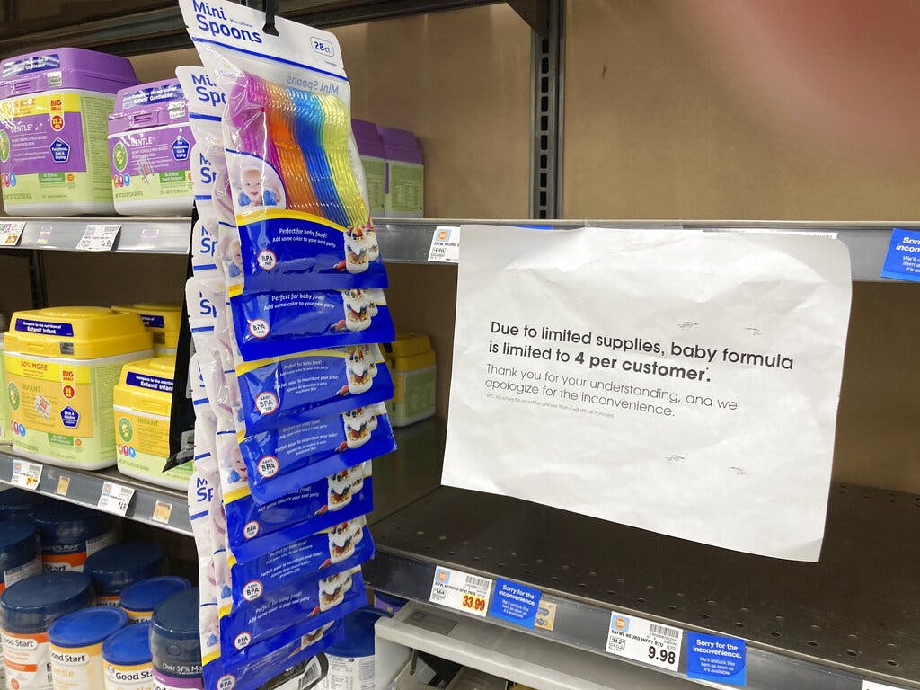 A sign outlining limits on the purchase of baby formula hangs on the edge of an empty shelf for the product in a King Soopers grocery store May 11, 2022, in southeast Denver. AP/David Zalubowski