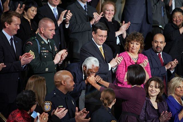 Haiti's ambassador to America, Raymond Joseph, kisses the hand of the first lady, Michelle Obama during President Obama’s State of the Union address in 2010. White House photo by Samantha Appleton via Wikimedia Commons
