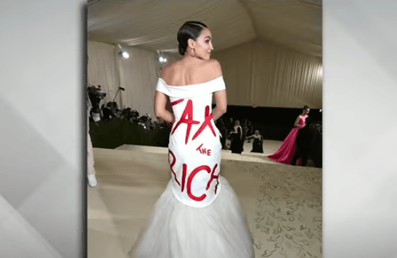 Via YouTube Representative Alexandria Ocasio-Cortez, wearing a dress that says 'Tax the Rich,' at the Met Gala in 2021.