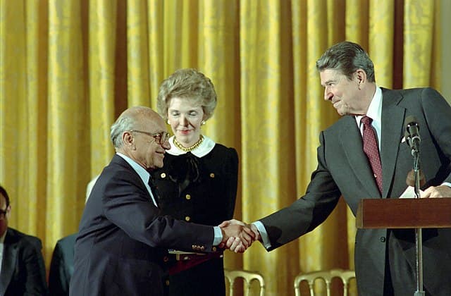 Via Wikimedia Commons President Reagan congratulating Milton Friedman on receiving the Presidential Medal of Freedom, October 17, 1988.