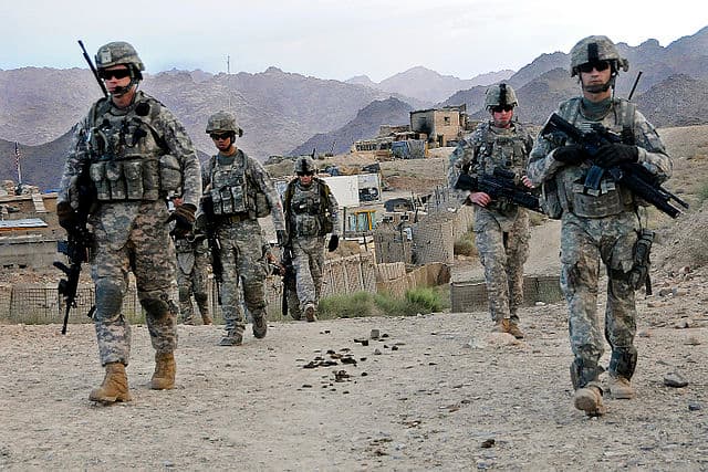 DoD photo, Staff Sgt. William Tremblay, U.S. Army/Released, via Wikimedia Commons American Soldiers departing Forward Operating Base Baylough, Afghanistan, on June 16, 2010, to conduct a patrol.