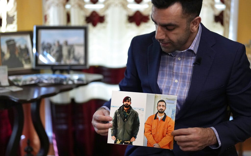 Sami-ullah Safi holds photographs of his brother, Abdul Wasi Safi, as he talks about his brother's journey to the U.S. January 18, 2023. 