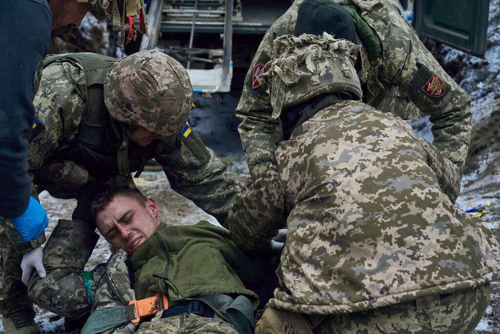 Military medics give first aid to a wounded soldier near Kremenna in the Luhansk region, Ukraine, January 16, 2023.