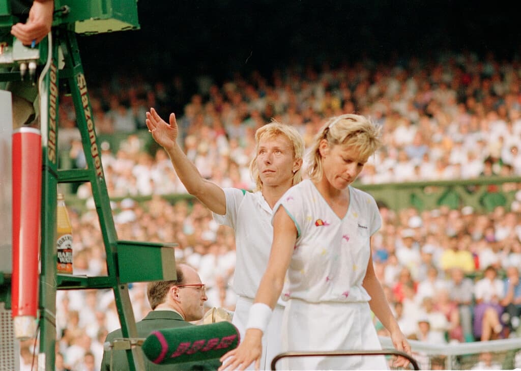 AP/Robert Dear The defending champion, Martina Navratilova, reaches to shake hands with the umpire as Chris Evert walks off court at Wimbledon, June 30, 1988.