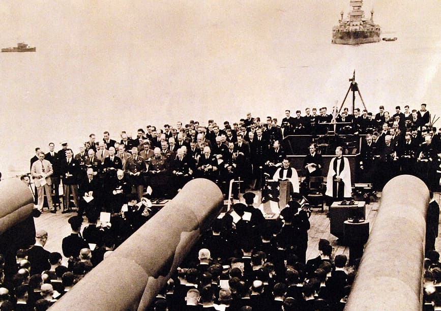 Via Wikimedia Commons FDR and Churchill at divine services onboard the Royal Navy battleship, His Majesty's Ship Prince of Wales, August 1941.