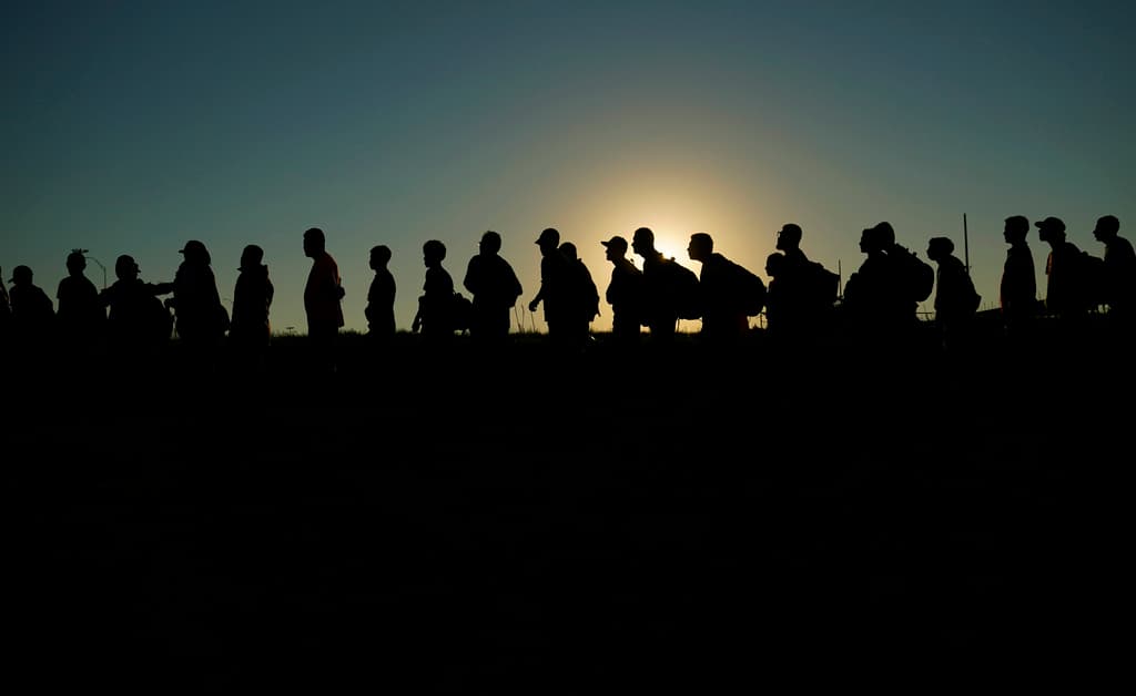 AP/Eric Gay Migrants who crossed the Rio Grande and entered America from Mexico during the Biden administration are lined up for processing by Customs and Border Protection at Eagle Pass, Texas.
