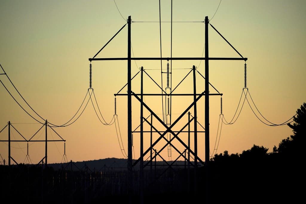AP Photo/Robert F. Bukaty Power utility lines at Pownal, Maine.