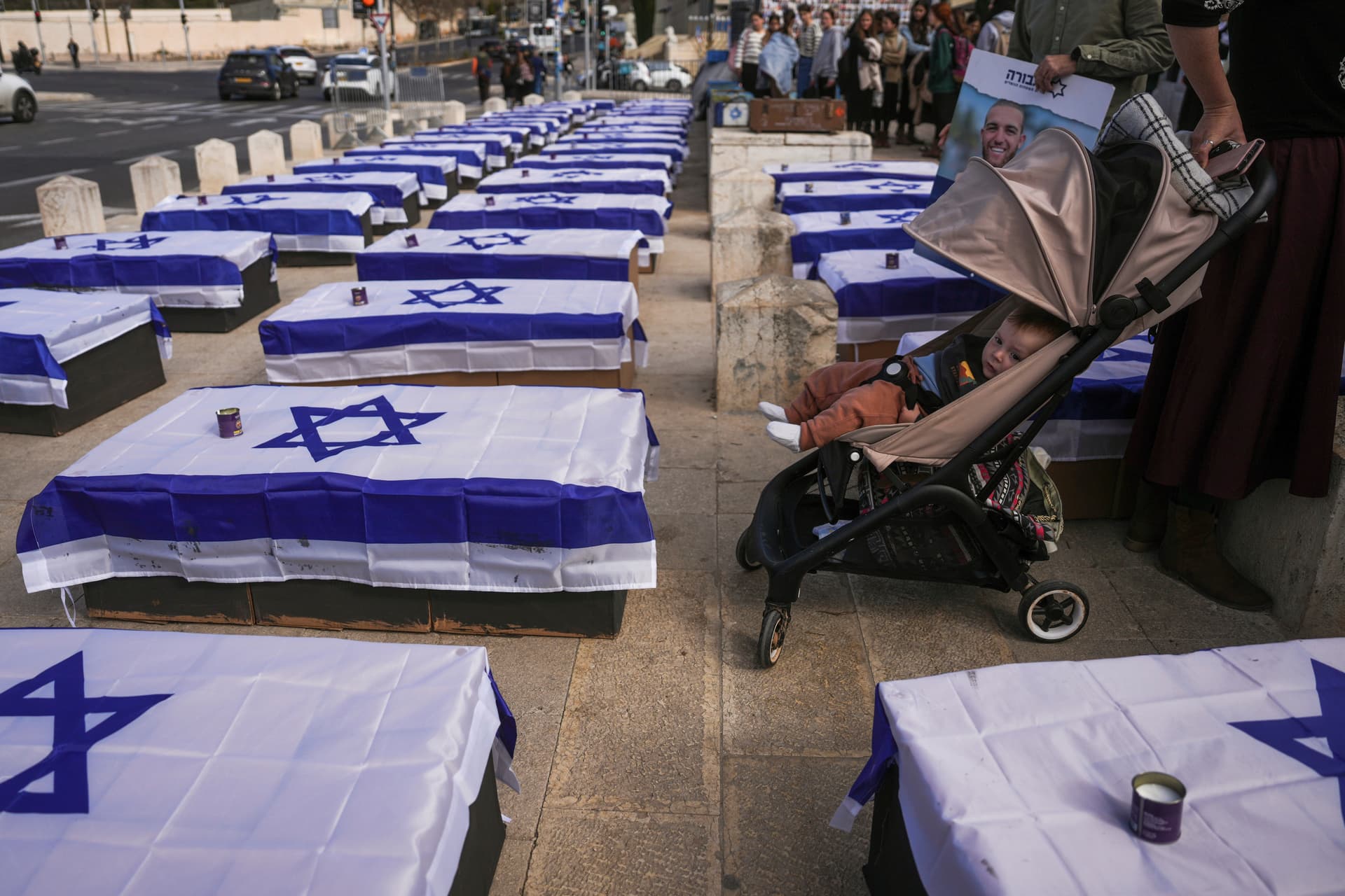 AP/Ohad Zwigenberg People stand by coffins lining a street and covered with Israeli flags that are meant to symbolize the price Israel will pay for agreeing to a ceasefire with Hamas in a demonstration against the deal staged by a group representing families of Israelis killed during the war in Gaza, at Jerusalem January 16, 2025.