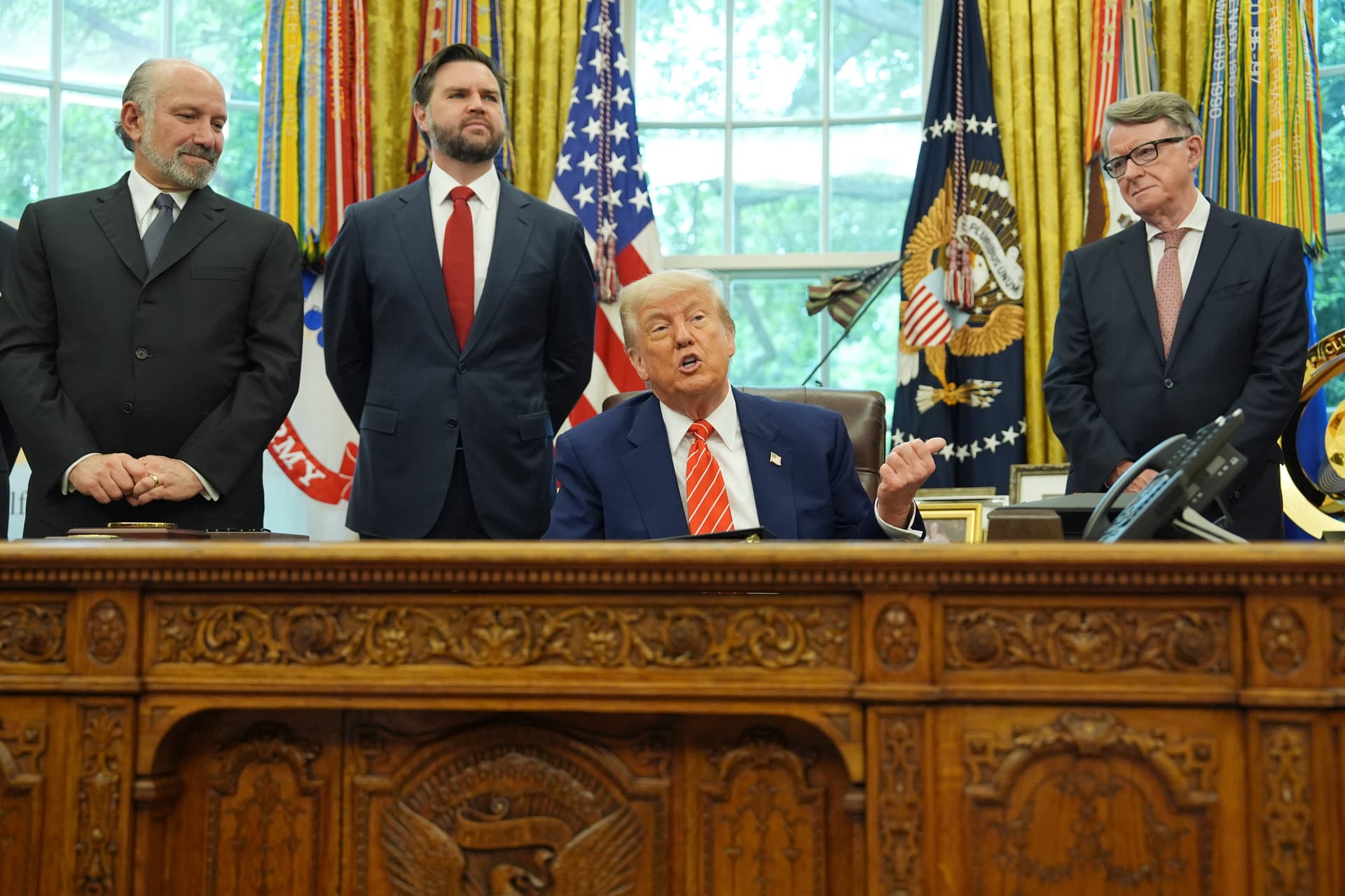 AP/Evan Vucci President Trump speaks as Commerce Secretary Howard Lutnick, Vice President JD Vance, and Britian's ambassador to the United States, Peter Mandelson, listen to remarks on a trade deal between the U.S. and U.K., on May 8, 2025, in the Oval Office at Washington, D.C.