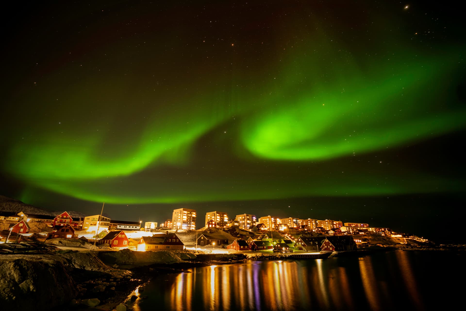 AP/Emilio Morenatti The northern lights appear over homes in Nuuk, Greenland, on Feb. 17, 2025.