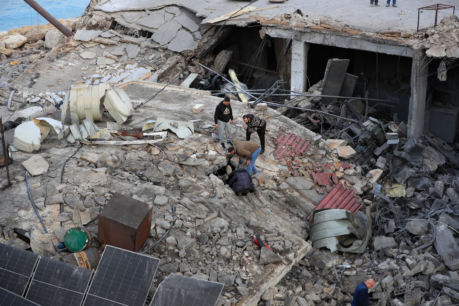AP/Mohammed Zaatari People look through the rubble of a destroyed building that was hit by an Israeli airstrike at a commercial district in the southern port city of Sidon, Lebanon, January 6, 2026.